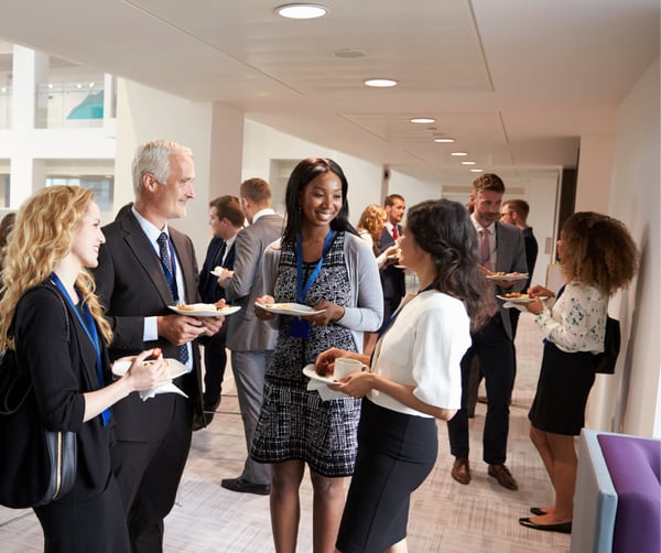 group of individuals talking in a hallway
