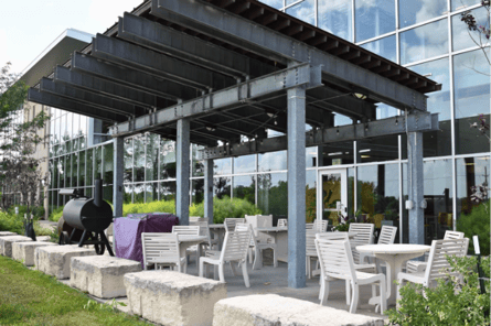A patio with a grill and chairs

AI-generated content may be incorrect.