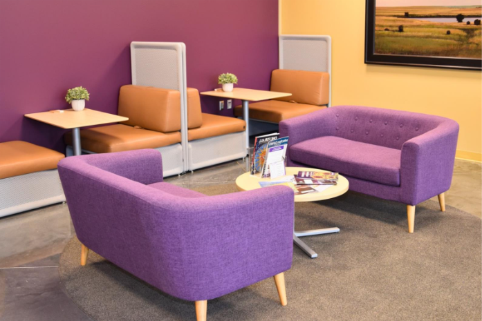A purple couches and tables in a room

AI-generated content may be incorrect.